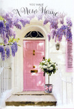 This photograph captures a dreamy Hornsey doorway that feels tailor-made for a housewarming card or new home celebration. At its heart is a pale pink door, subtle and soothing, its paint smooth and gently glowing in the natural light. A coordinating shutter continues the same blush tone, set against whitewashed walls that reflect the daylight softly rather than sharply. Overhead, a profusion of wisteria cascades like a floral waterfall, with long clusters of lavender and lilac blossoms hanging in loose, romantic swags. The flowers form a natural archway above the entrance, their trailing shapes and feathery texture adding a sense of movement and intimacy, much like the hidden corners of Hornsey's residential streets near Alexandra Palace. Beneath this canopy of blooms, at the very edge of the threshold, a stylish metal bucket is placed on the step. Inside, a carefully arranged bouquet of creamy white roses and fresh green foliage overflows, the roses fully open and layered like soft ruffles of fabric. The foliage peeks between the blooms, lending depth and a fresh garden character. A soft pink ribbon encircles the base of the bucket, its satiny sheen catching the light and echoing the gentle colour of the door and shutter. The stone steps are lightly bathed in sunshine, with delicate shadows falling across them and guiding your gaze upward to the flowers. The entire scene feels serene, welcoming, and filled with quiet joy-as if Hornsey Florist has just delivered this arrangement to mark the keys changing hands, blessing the new home with beauty, fragrance, and a sense of being truly, lovingly welcomed.